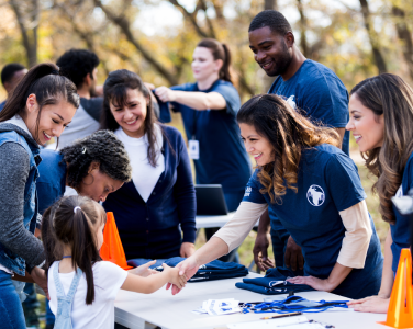 volunteer shaking hands with kid