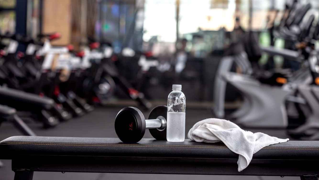 water bottle and dumbbell on bench