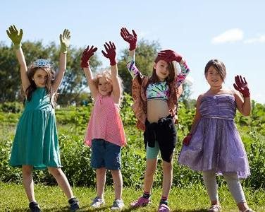 Four Summer Camp participants out at the community garden