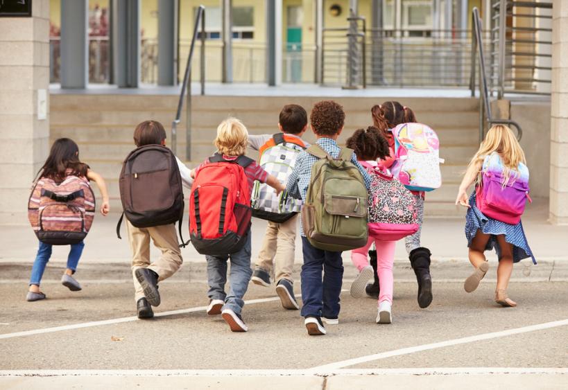 Des enfants courant vers l’école