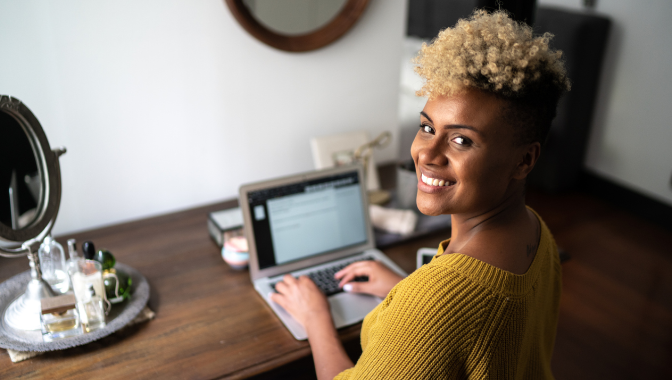 woman looking back from laptop