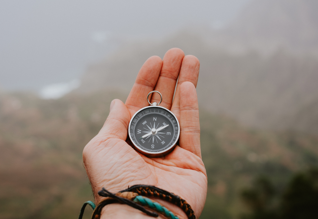 hand holding compass