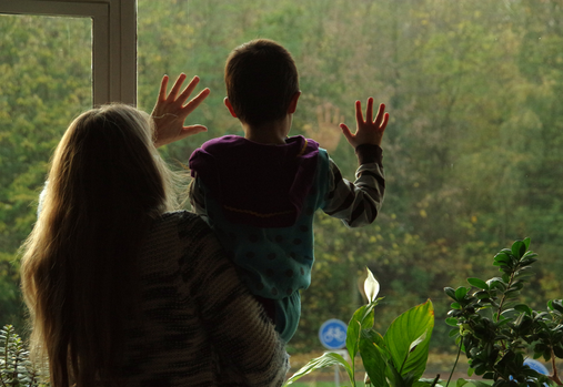 Woman and child waving at window