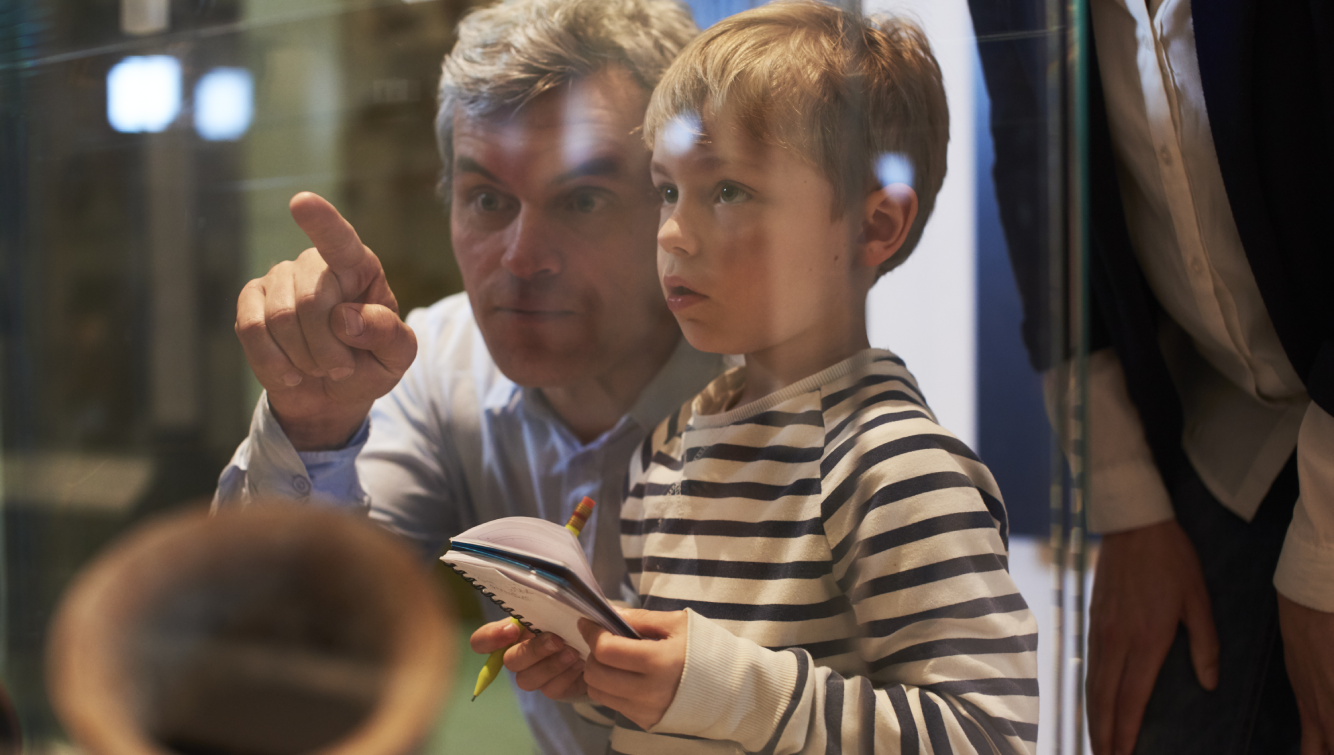 father and son looking at exhibit