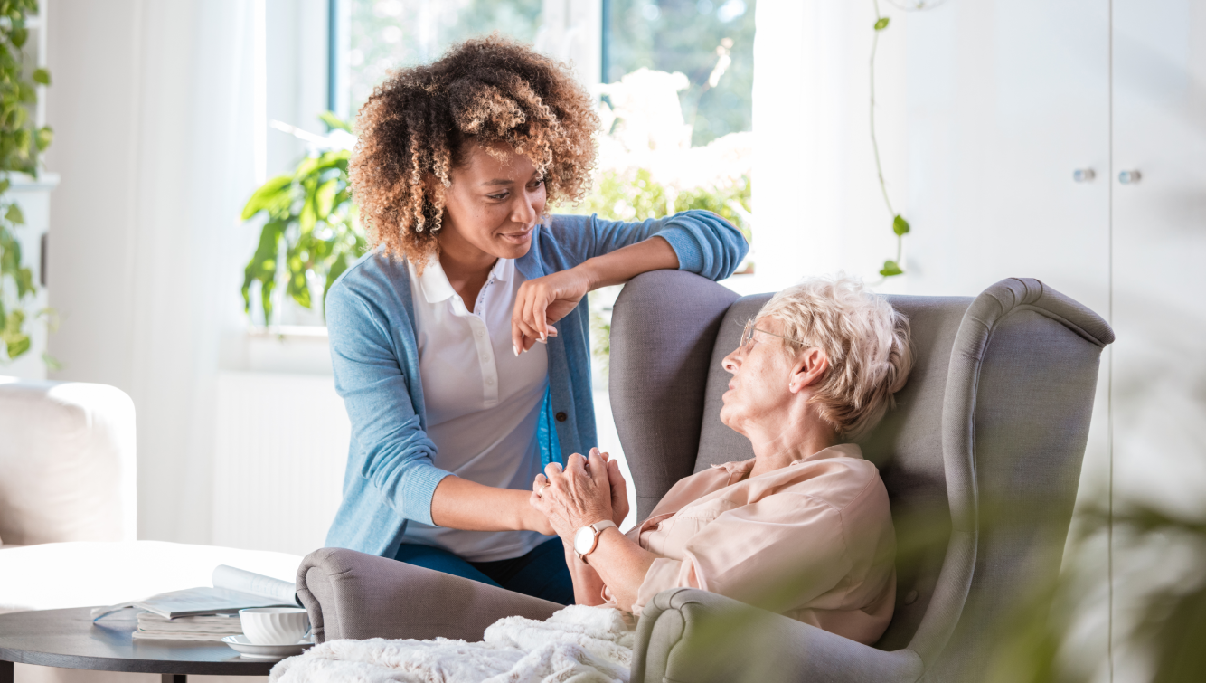 young woman holding hands with older woman