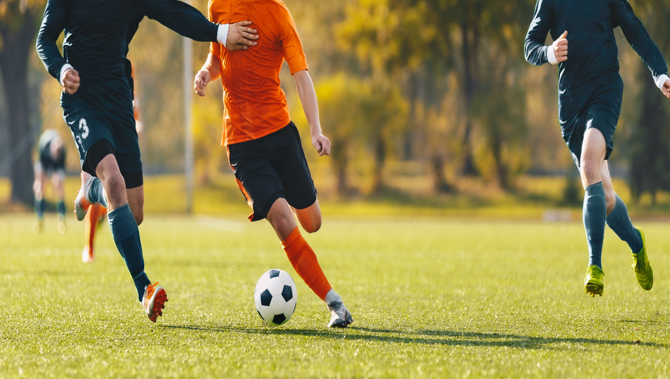 2 men playing soccer