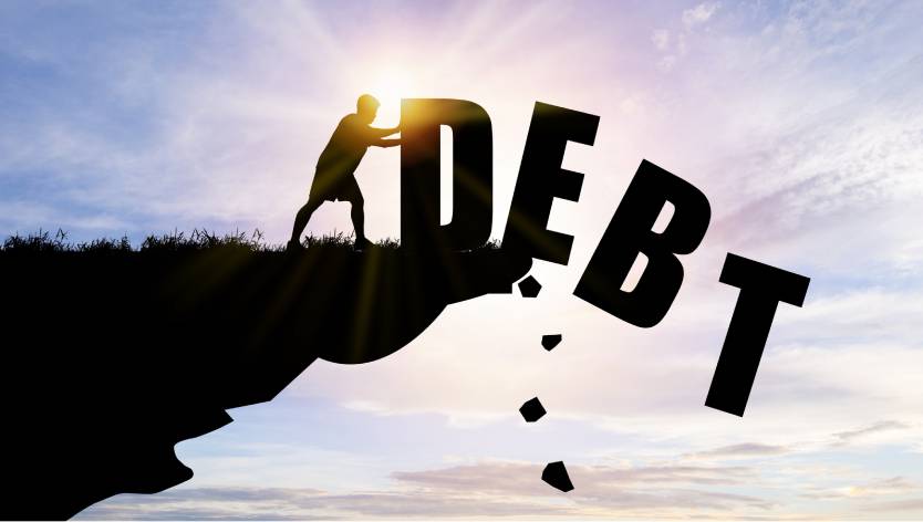 person pushing Debt off a cliff