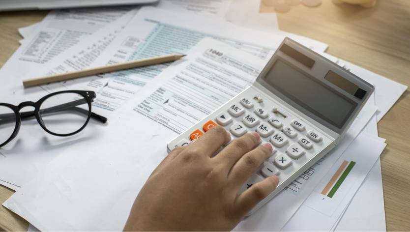 Hand and calculator