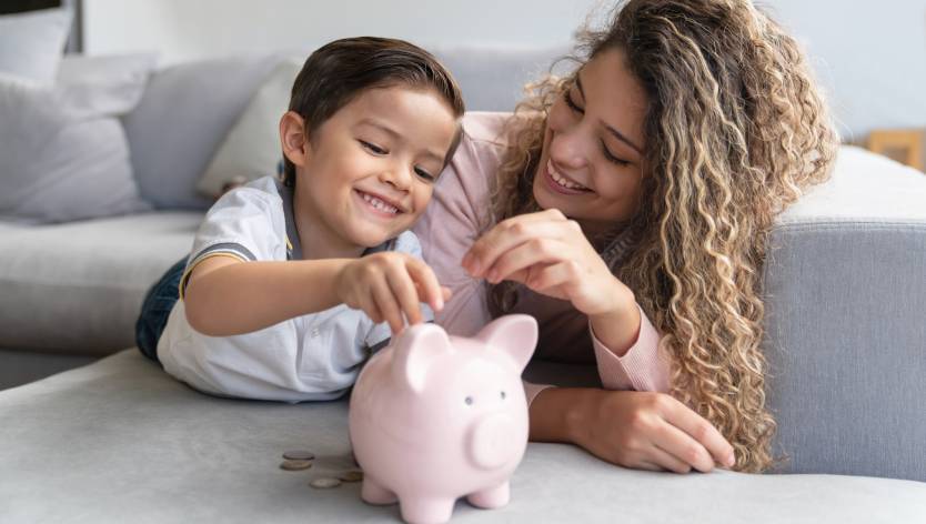 mom and son with a piggybank