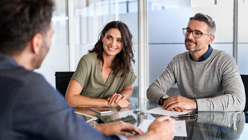 Man and woman talking to advisor