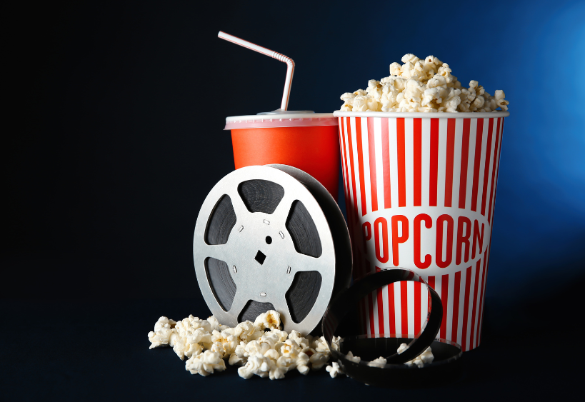 Une image d’une bobine de film accompagnée de popcorn et d’une boisson gazeuse